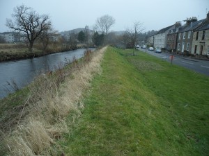 Flood defence embankment in Bridge of Allan, the right hand side is a flood risk area.