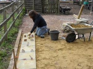 A volunteer hard at work laying the base which is now complete.